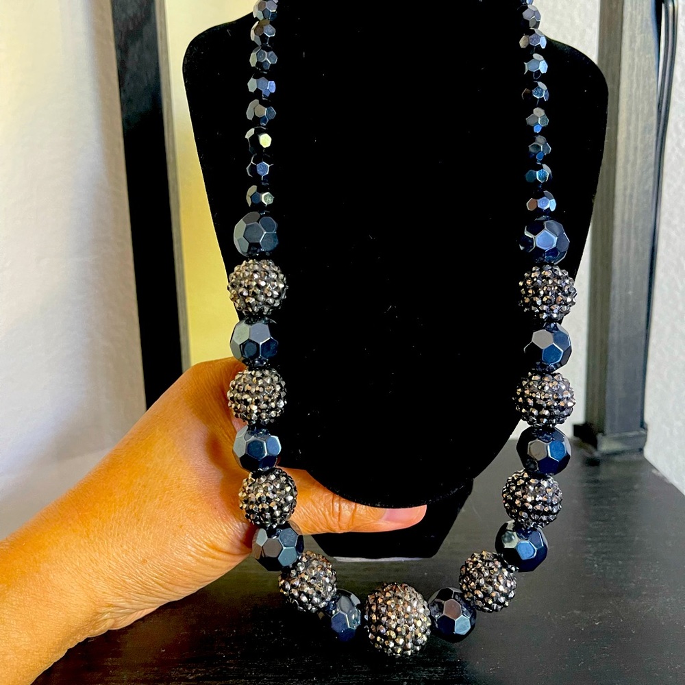 Beautiful Costumes jewelry necklace adorned with dark ocean blue beads.